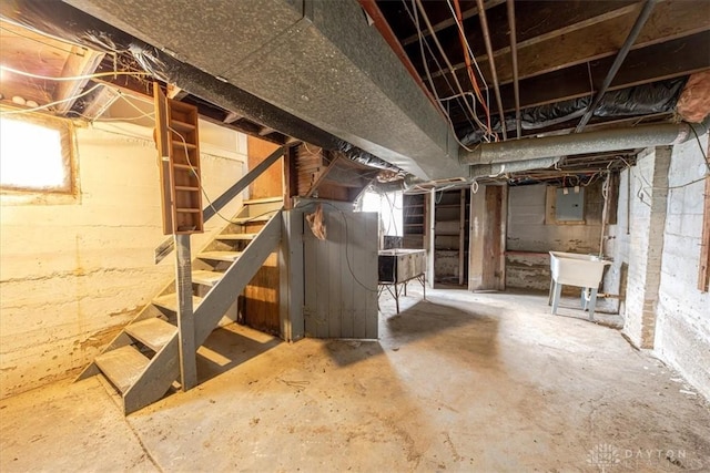 basement featuring electric panel and sink