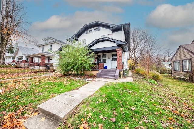 view of front of home with a porch and a front yard