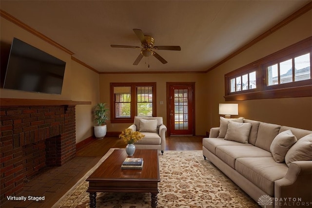 living room featuring ceiling fan, a healthy amount of sunlight, dark hardwood / wood-style floors, and ornamental molding