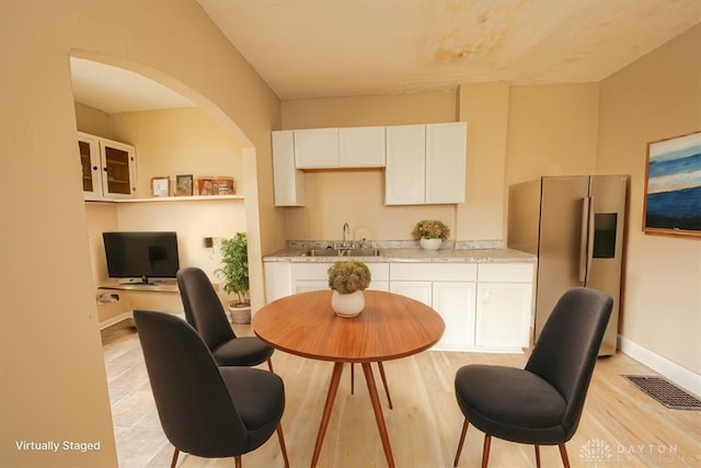 dining space featuring sink and light hardwood / wood-style flooring