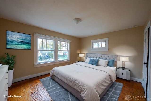 bedroom featuring dark hardwood / wood-style floors and multiple windows