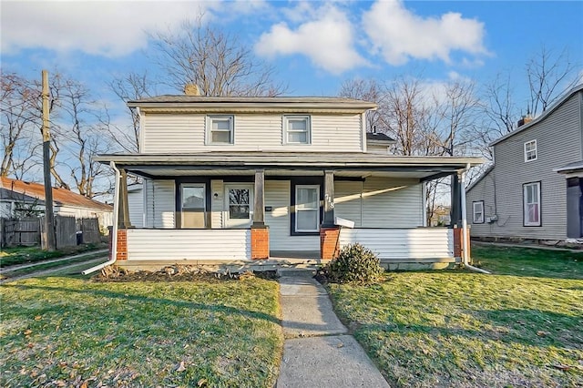 view of front of home with covered porch and a front yard