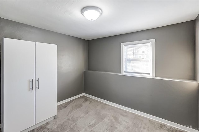 unfurnished bedroom with light colored carpet