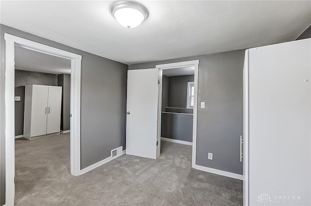 unfurnished bedroom with light carpet