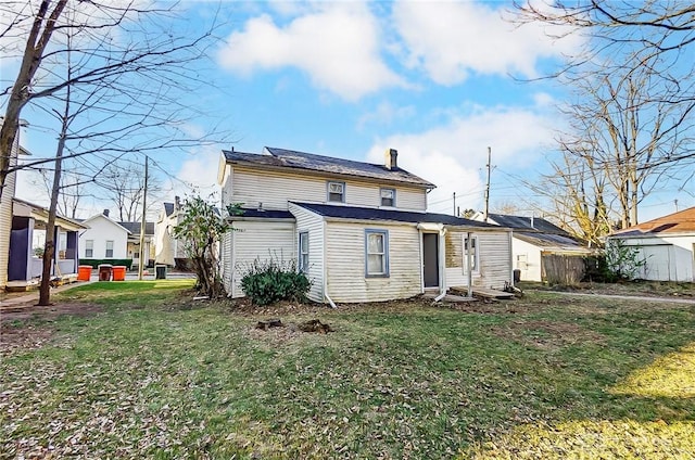 back of house with a lawn