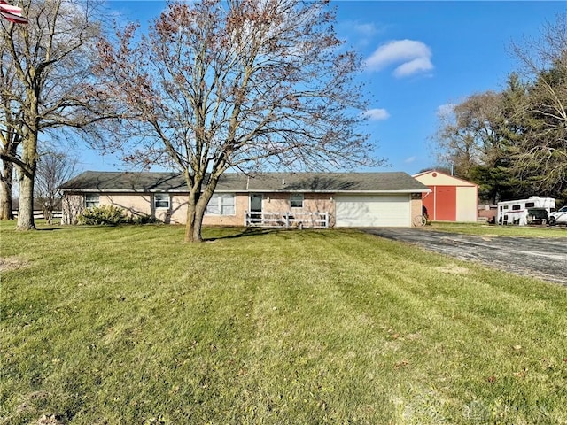 single story home with a front yard and a garage