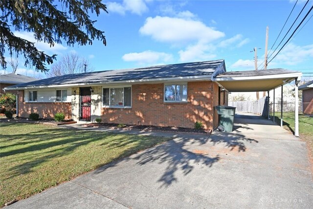 view of front facade featuring a front lawn and a carport