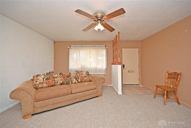 carpeted living room with a textured ceiling and ceiling fan