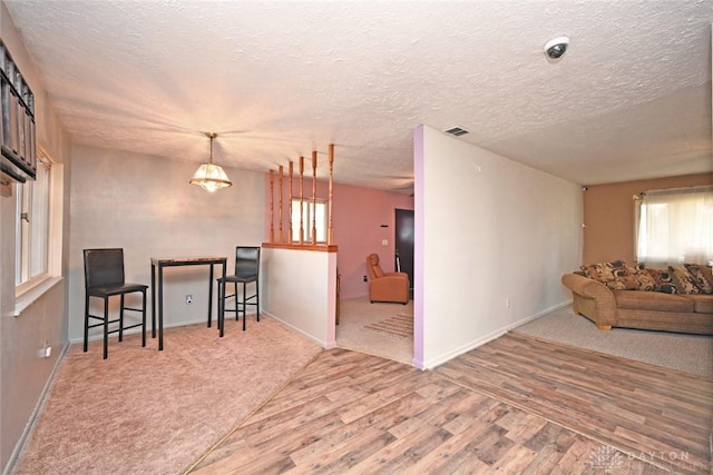 interior space featuring a textured ceiling and hardwood / wood-style flooring