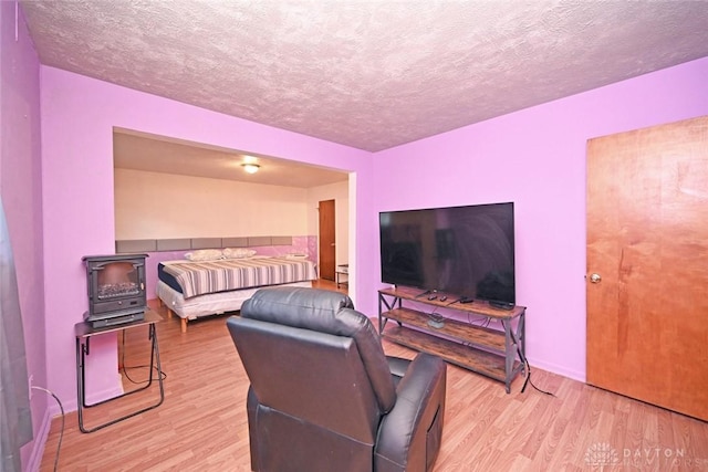 bedroom featuring light hardwood / wood-style flooring and a textured ceiling