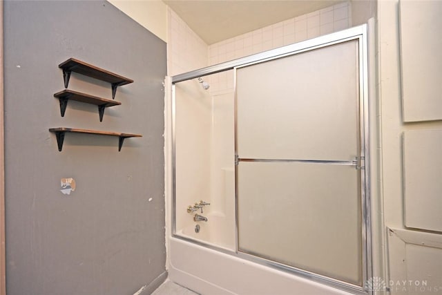 bathroom featuring shower / bath combination with glass door