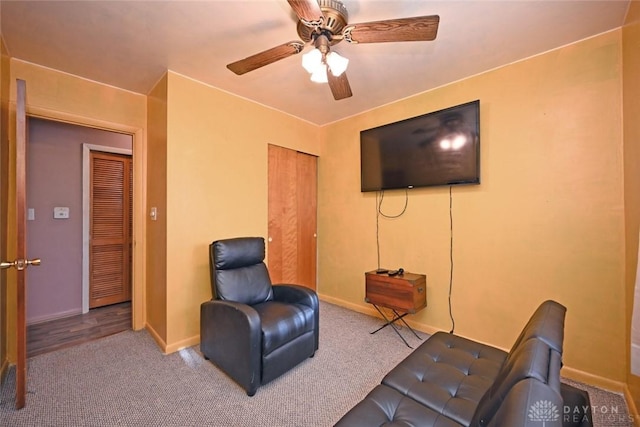 carpeted living room with ceiling fan