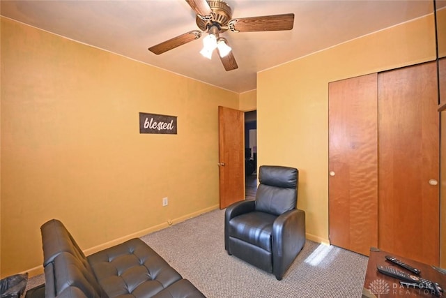 living area with ceiling fan and carpet floors