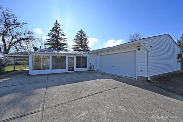 ranch-style home with a sunroom, a garage, and a carport