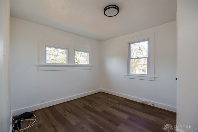 spare room featuring dark hardwood / wood-style floors