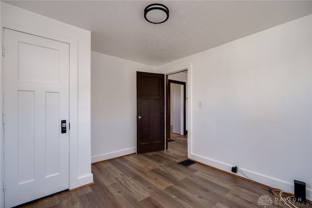 unfurnished room with hardwood / wood-style floors