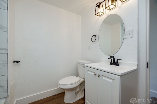 bathroom featuring vanity, hardwood / wood-style flooring, and toilet