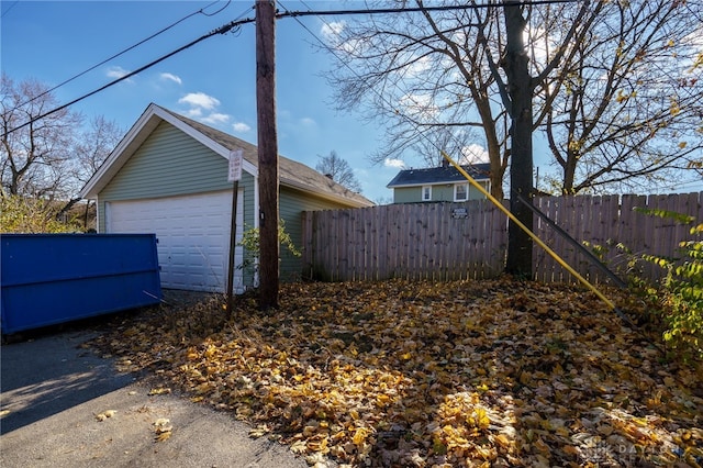 view of side of home featuring a garage and an outdoor structure