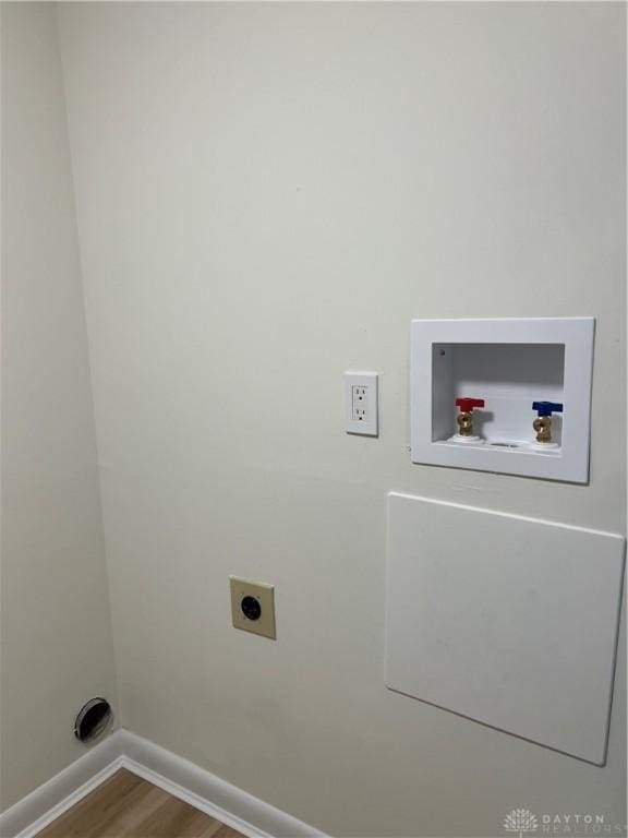 laundry area with electric dryer hookup, hookup for a washing machine, and hardwood / wood-style floors