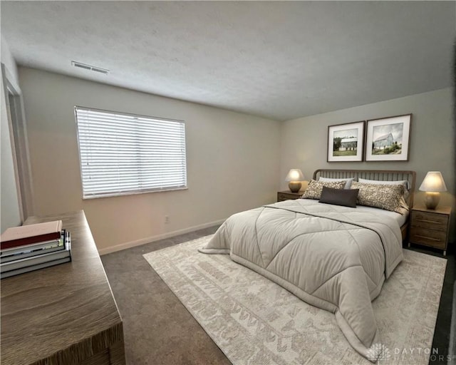 carpeted bedroom featuring a textured ceiling