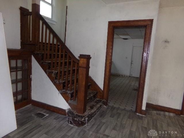 stairs featuring visible vents and wood finished floors