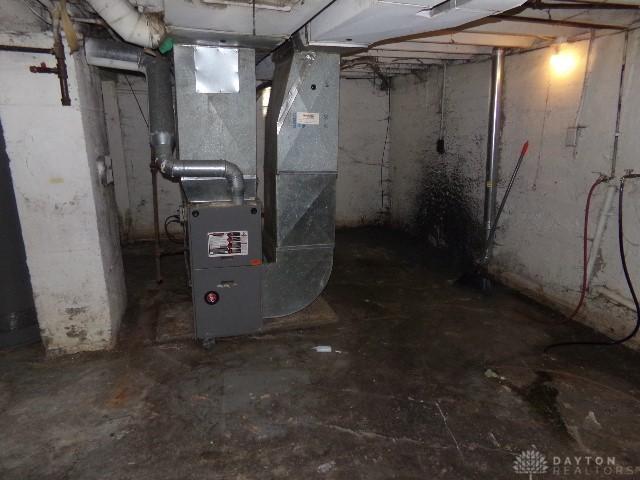 unfinished basement featuring heating unit