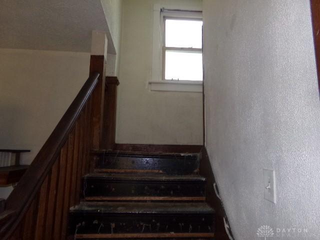 stairs with a textured wall