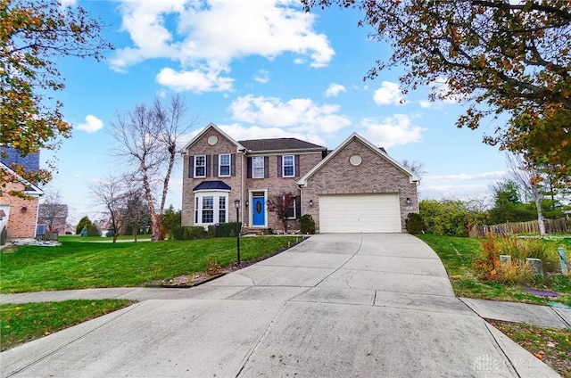 view of front of house with a garage and a front lawn