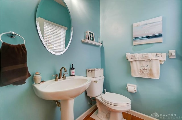 bathroom with sink, hardwood / wood-style floors, and toilet