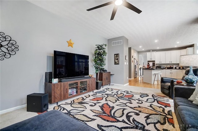 carpeted living room featuring ceiling fan