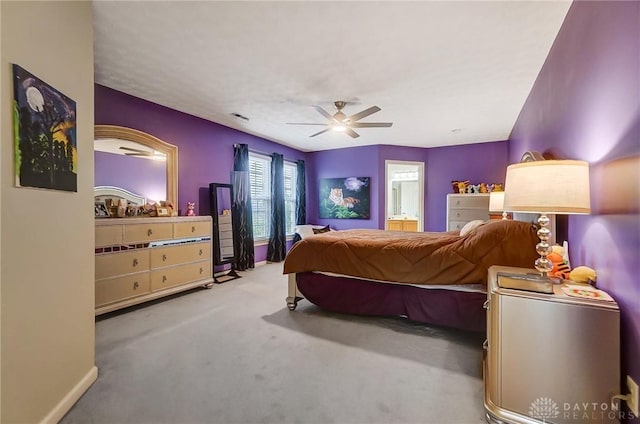 carpeted bedroom with ceiling fan and ensuite bathroom