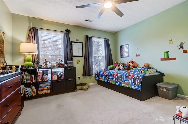 bedroom featuring ceiling fan and light carpet