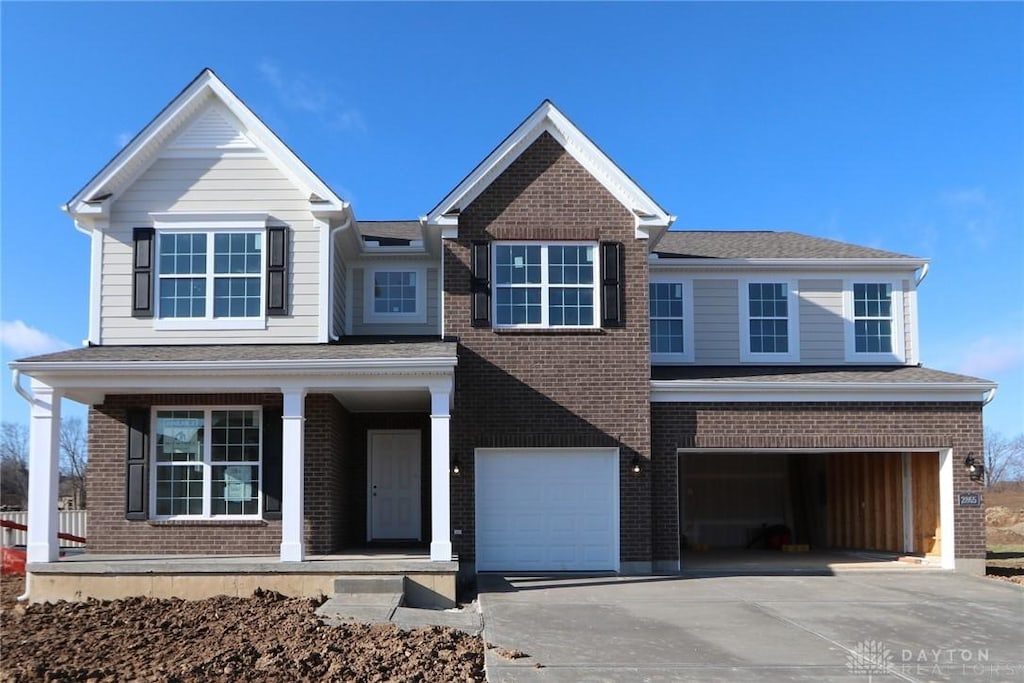 view of front of property with covered porch and a garage