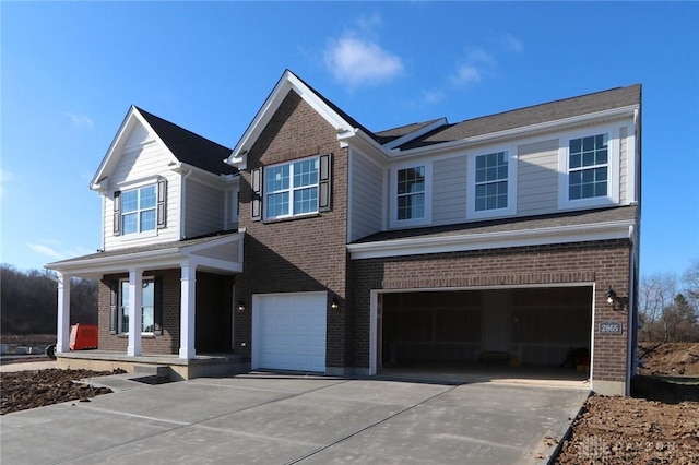 view of front of home featuring a porch and a garage