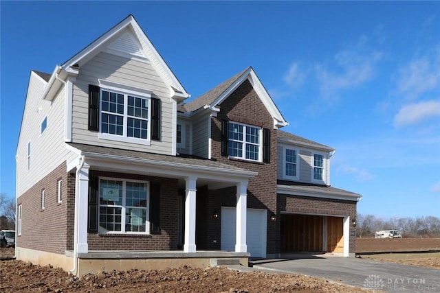 view of front of house with a porch and a garage