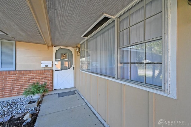 entrance to property featuring brick siding