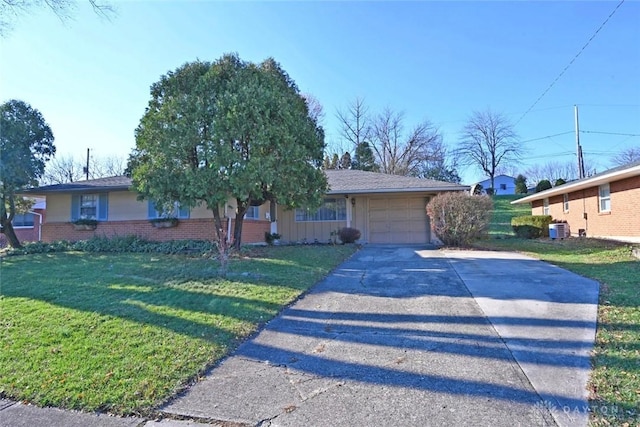 ranch-style home featuring an attached garage, cooling unit, brick siding, concrete driveway, and a front lawn