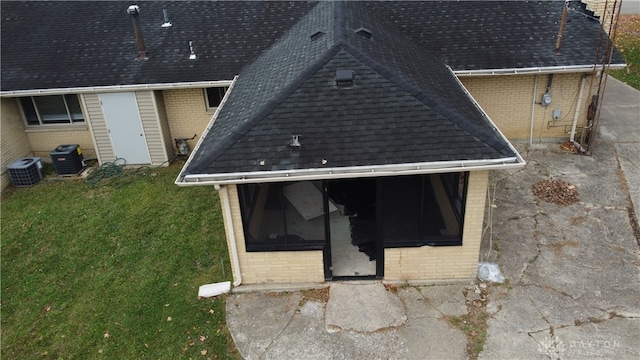 1246 Angiers Dr, Dayton, OH 45417 - exterior details featuring gutters, roof with shingles, cooling unit, a downspout, and brick siding