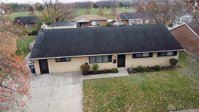 1246 Angiers Dr, Dayton, OH 45417 - ranch-style home with brick siding, a chimney, a front lawn, and roof with shingles