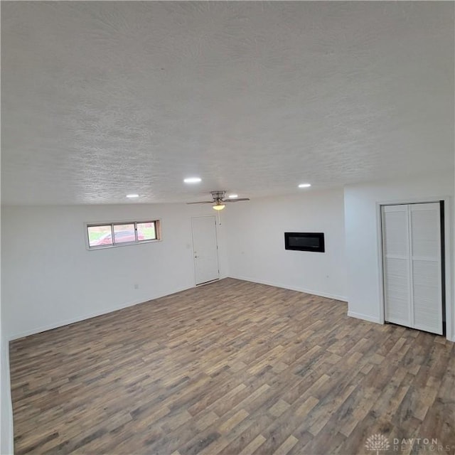 basement with wood-type flooring and a textured ceiling