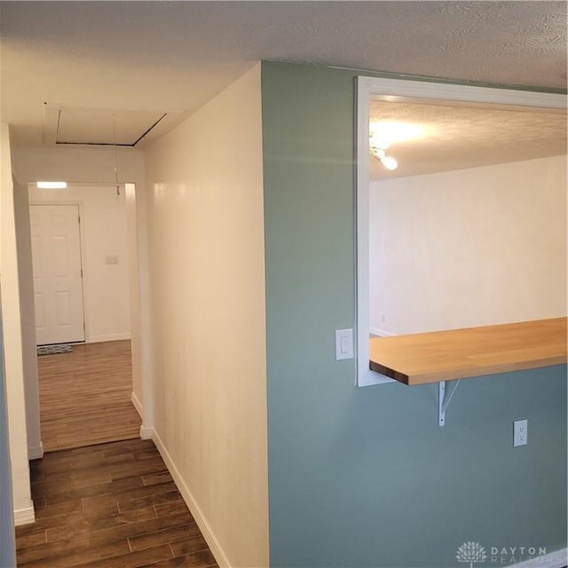 1246 Angiers Dr, Dayton, OH 45417 - hallway with dark wood-style floors, a textured ceiling, attic access, and baseboards