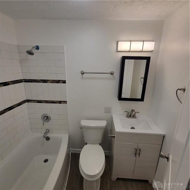 full bathroom featuring hardwood / wood-style floors, vanity, a textured ceiling, and toilet