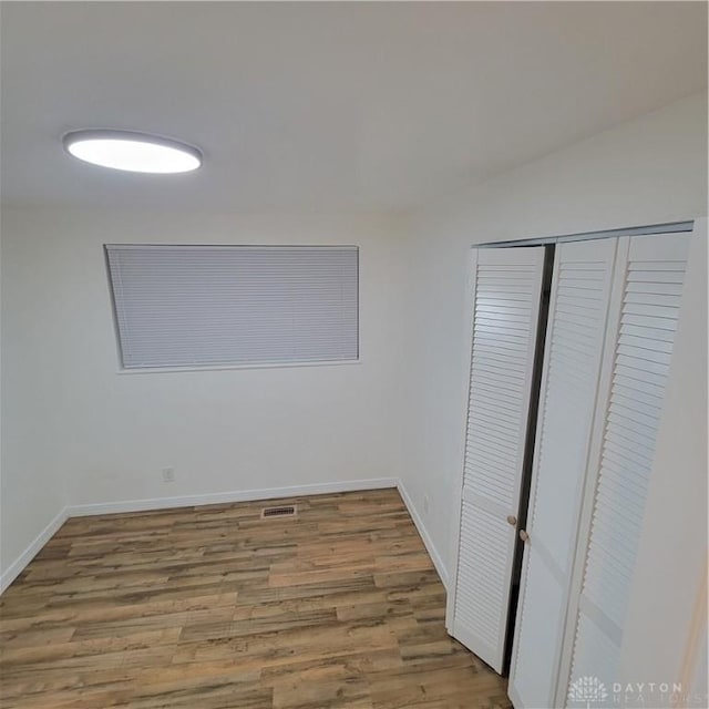 unfurnished bedroom featuring hardwood / wood-style flooring