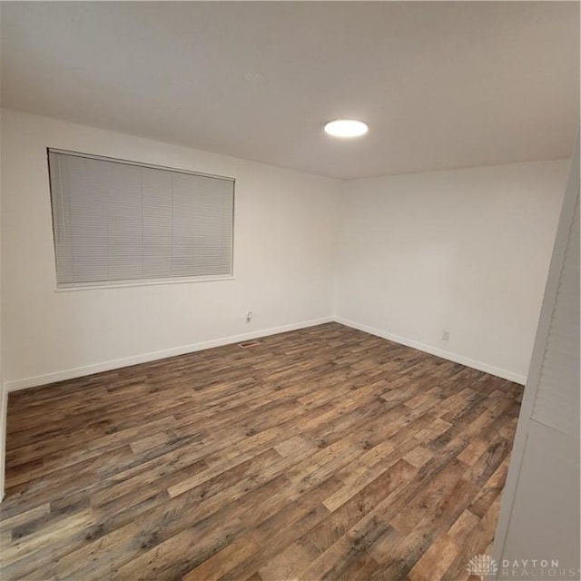 spare room with dark hardwood / wood-style floors