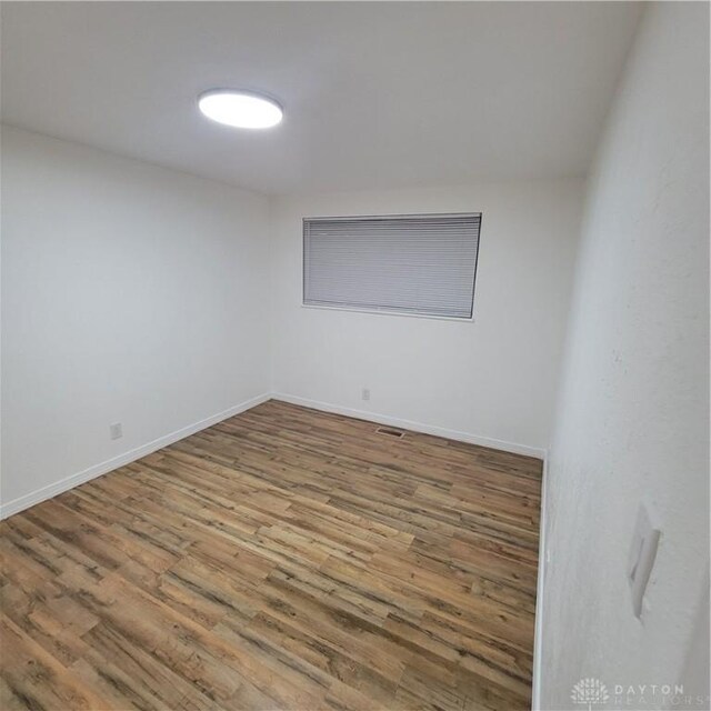 spare room with hardwood / wood-style floors