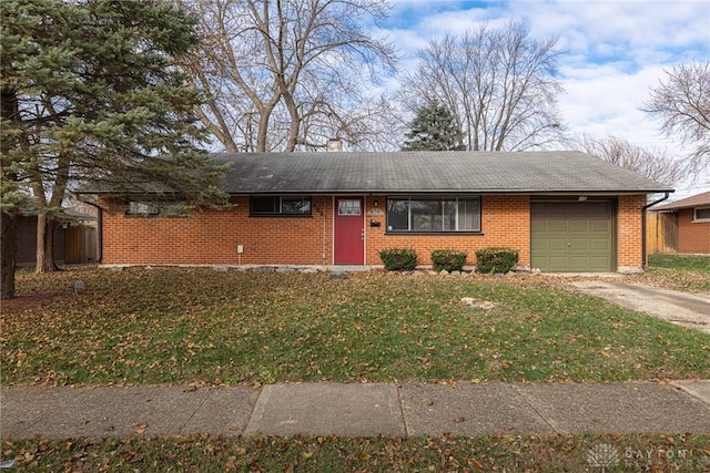 ranch-style home with a garage and a front yard