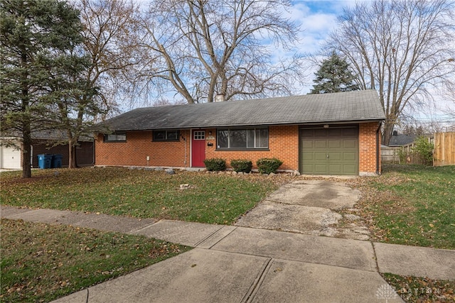 single story home with a garage and a front lawn