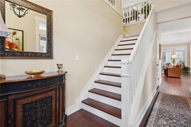 staircase with hardwood / wood-style flooring