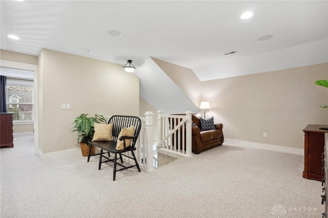 sitting room featuring light carpet and vaulted ceiling