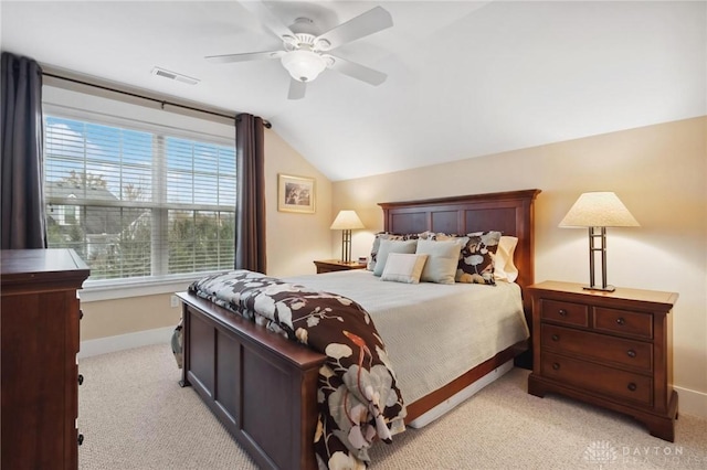 bedroom with ceiling fan, light colored carpet, and vaulted ceiling